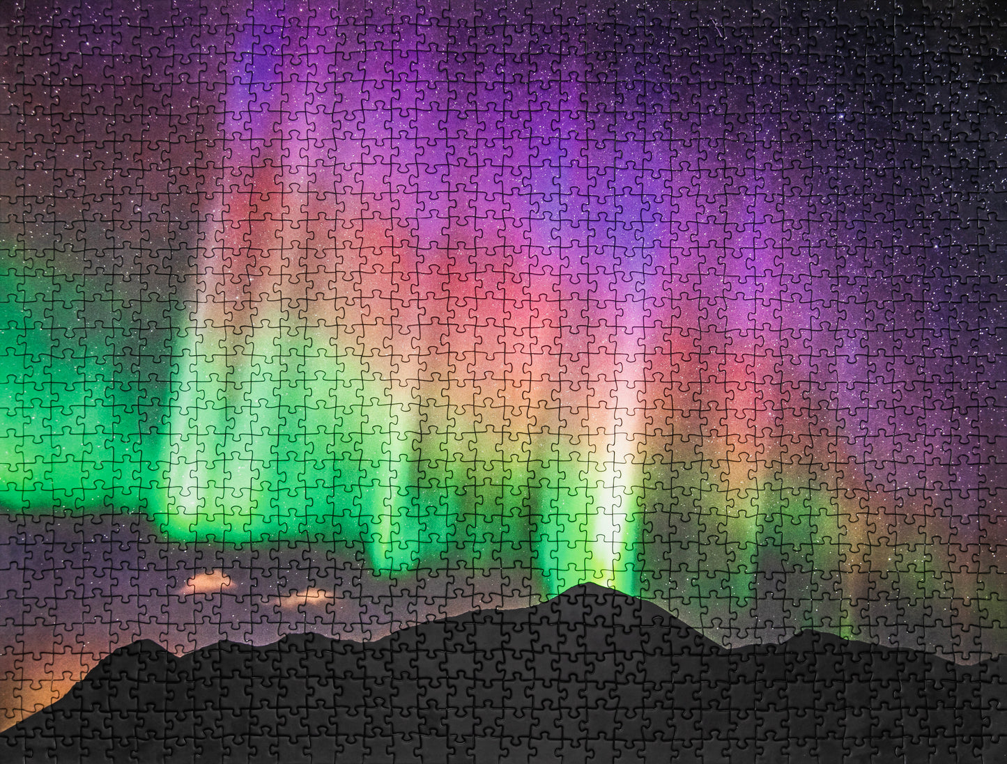 Jigsaw puzzle with a colorful Northern Lights design on a dark background