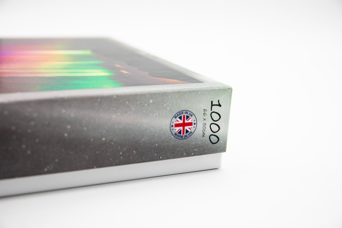 Jigsaw puzzle box with a rainbow design and Union Jack flag on a white background