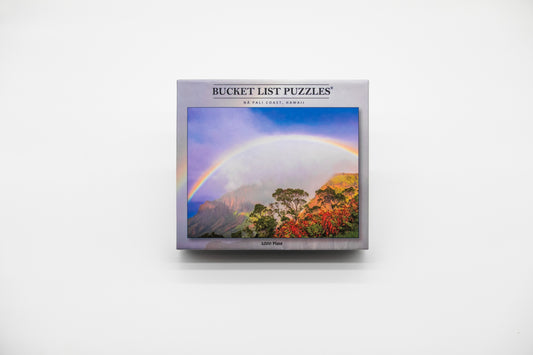 Bucket List Puzzles packaging with a rainbow and mountain design on a white background