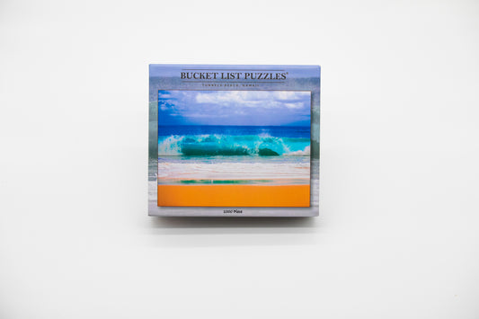 Bucket List Puzzles packaging with a beach scene on a white background
