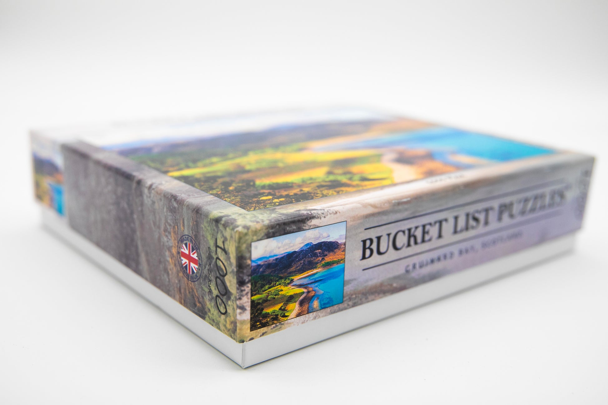 Jigsaw puzzle box with scenic images and 'Bucket List Puzzles' text on a white background