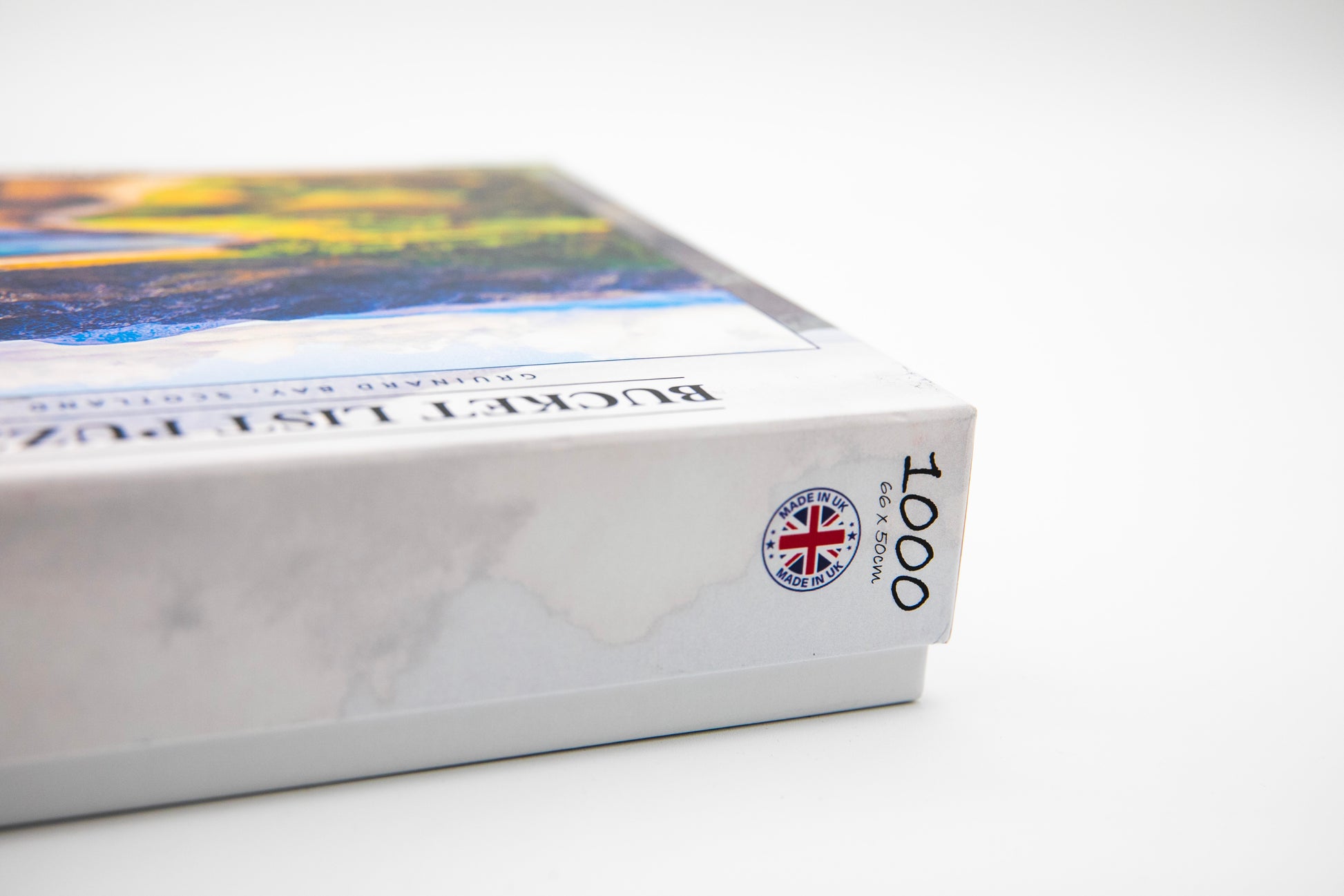 Close-up of a book with a colorful cover and a visible brand logo on a white background